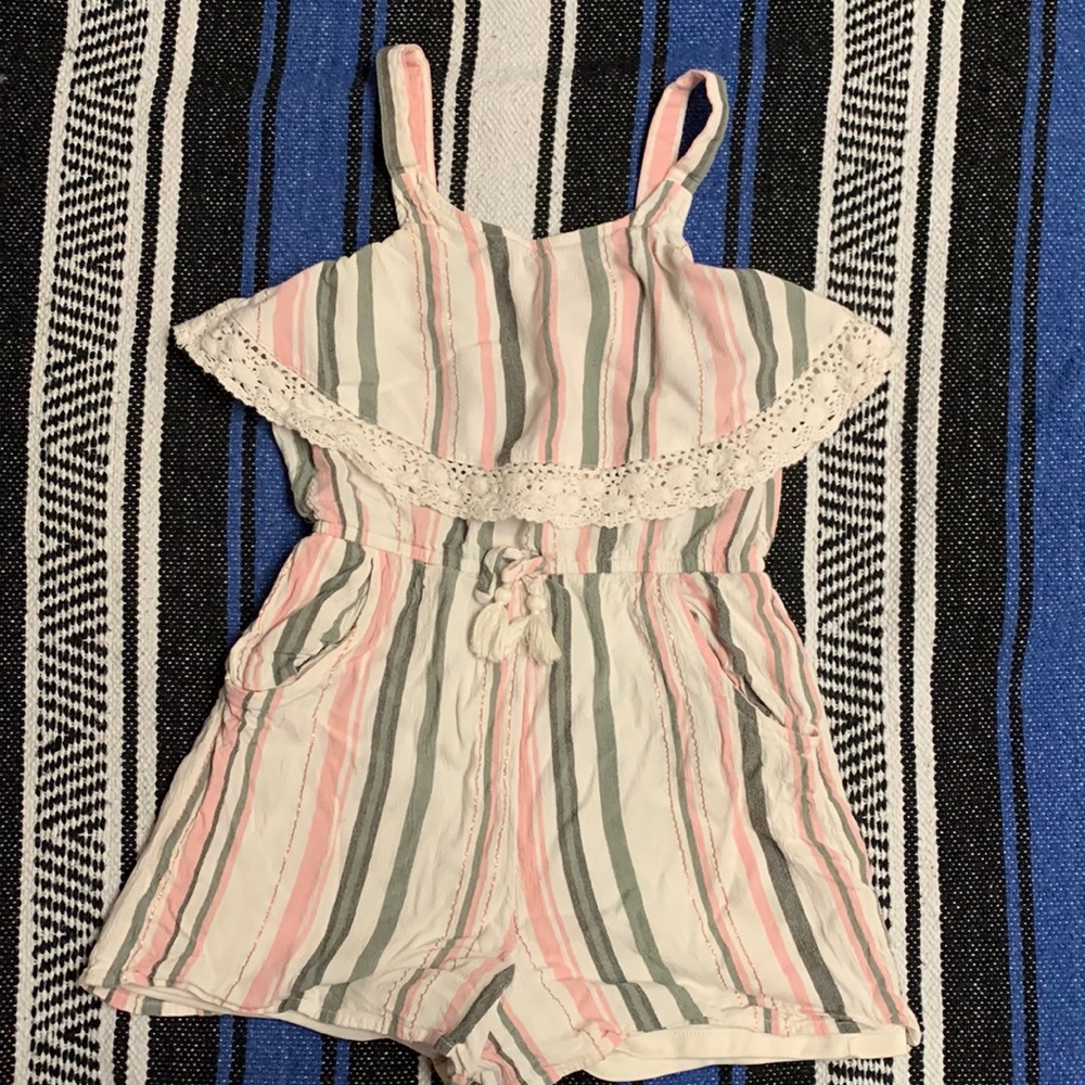 This is a one piece romper. It is Gold, light pink,sage green, and a light gray.